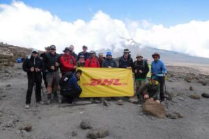 DHL sign group picture on a Kilimanjaro bespoke trip